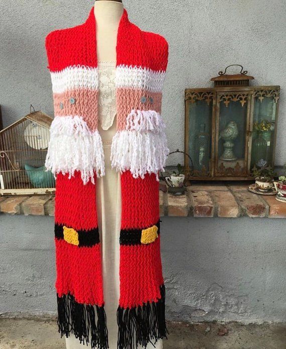 a red and white knitted santa clause vest