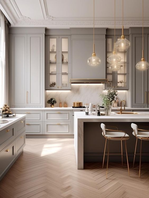 a kitchen with white cabinets and wooden floors, two bar stools at the island