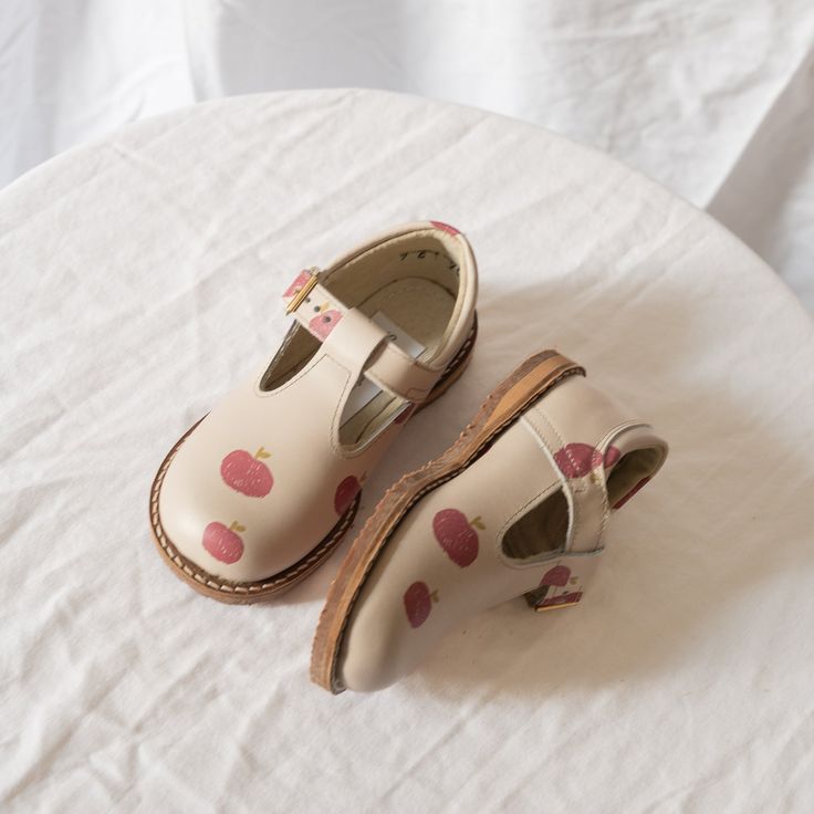 The Flora T-Strap in our fall Apple print is made of camel top grain leather and lined in breathable leather which wicks away moisture. The structure of the shoe and the flexible rubber sole provide stability without weight to support your little one's early steps. Perfect for fall weather! Saddle Oxfords, Apple 7, Apple Print, Apple Prints, Fall Apples, Fall Weather, Dove Grey, Blue Ivory, Top Grain Leather