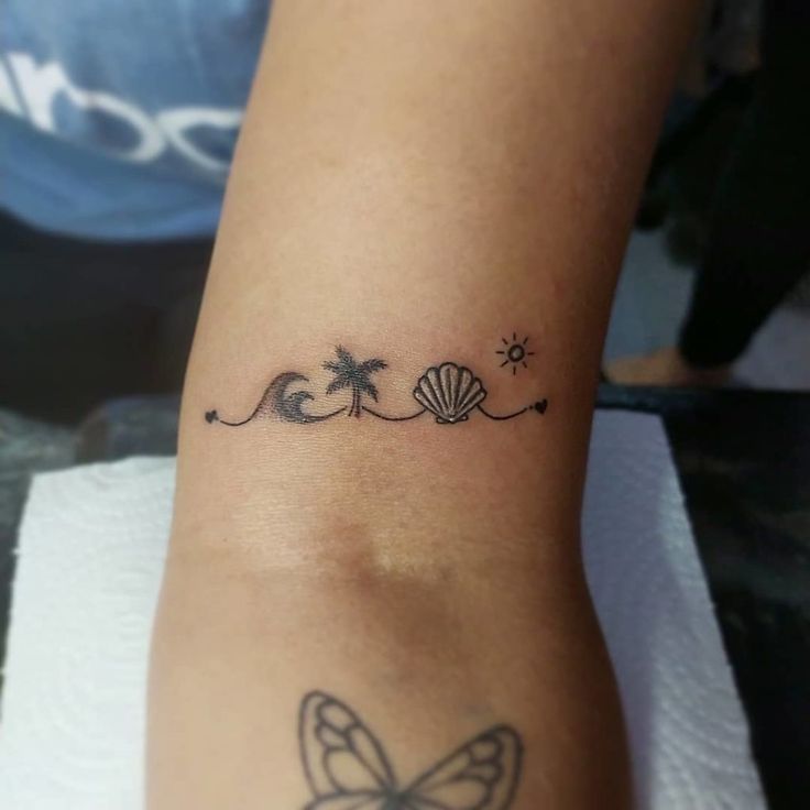 a woman's foot with a tattoo on it and a butterfly in the middle