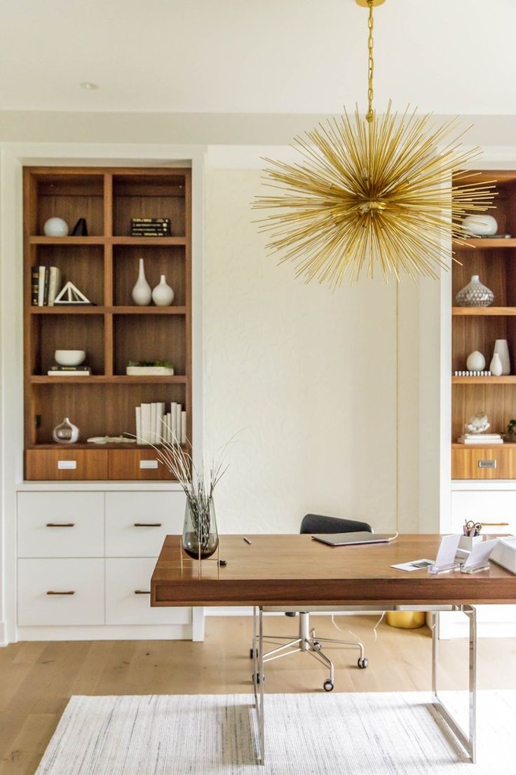 a dining room table with chairs and bookshelves