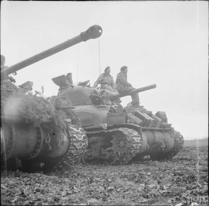 an old black and white photo of men on tanks