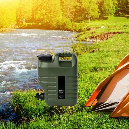 an orange tent next to a green and brown camping set up on the grass near a river