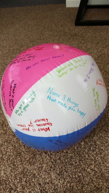 a beach ball with writing on it sitting on the floor