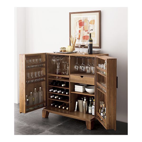 a wooden cabinet filled with lots of bottles and glasses