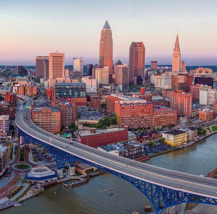 an aerial view of a city with tall buildings and a bridge in the foreground