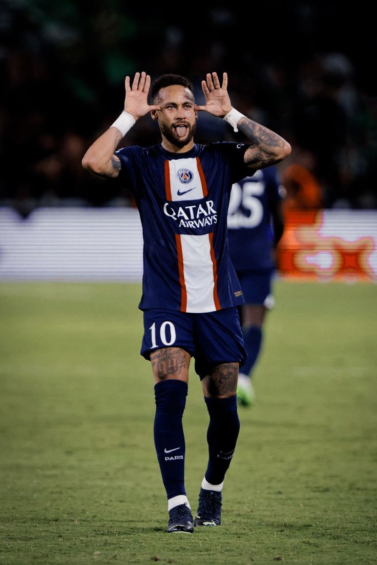 a soccer player with his hands in the air