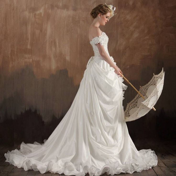 a woman in a wedding dress holding an umbrella