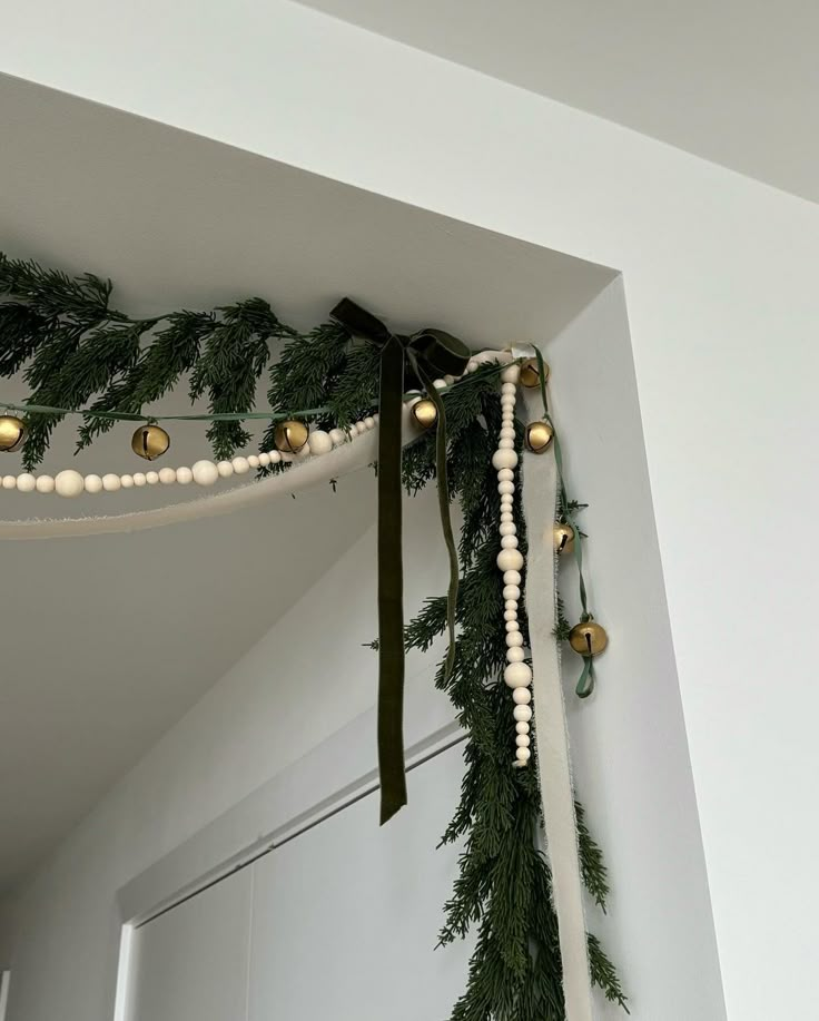 the garland is hanging from the ceiling with lights and ornaments on it's side