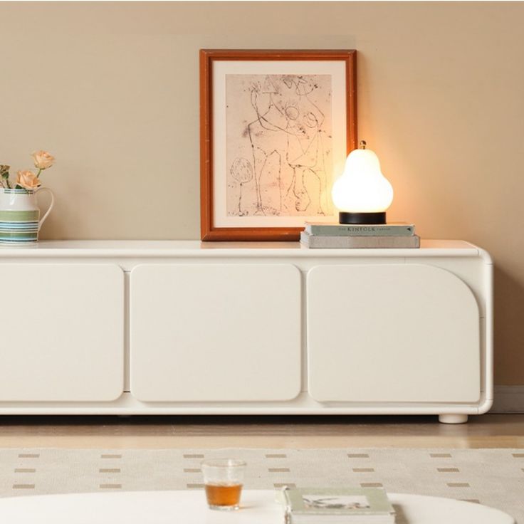 a living room scene with focus on the sideboard and coffee table in the foreground