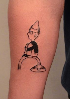 a tattoo on the arm of a person with a black and white image of a cartoon character