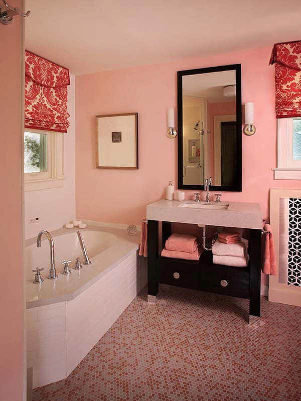 a bathroom with pink walls and white fixtures