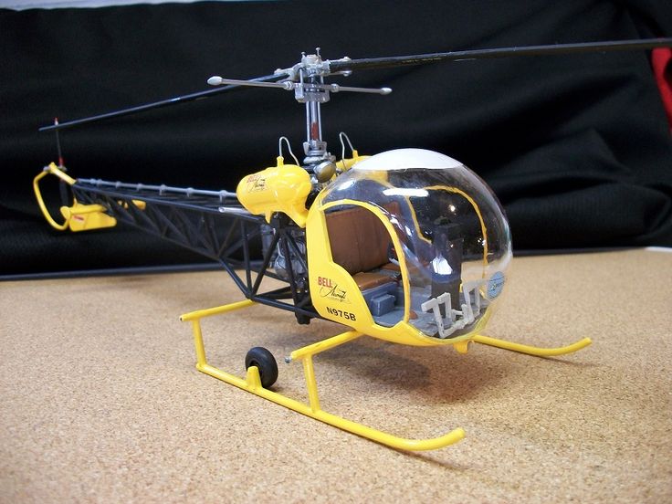 a yellow and black helicopter sitting on top of a table