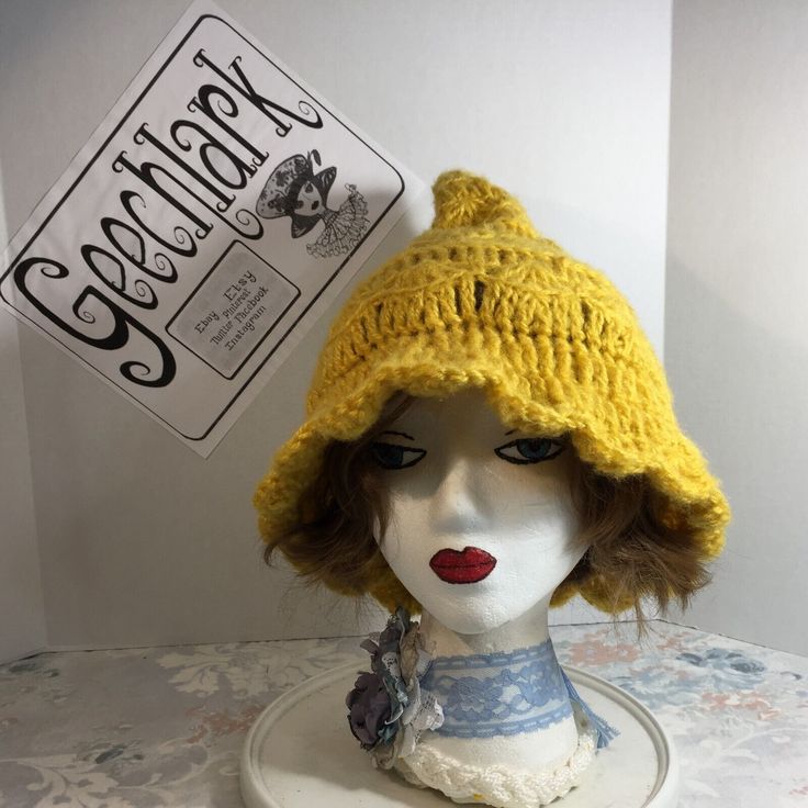 a mannequin head wearing a yellow knitted hat