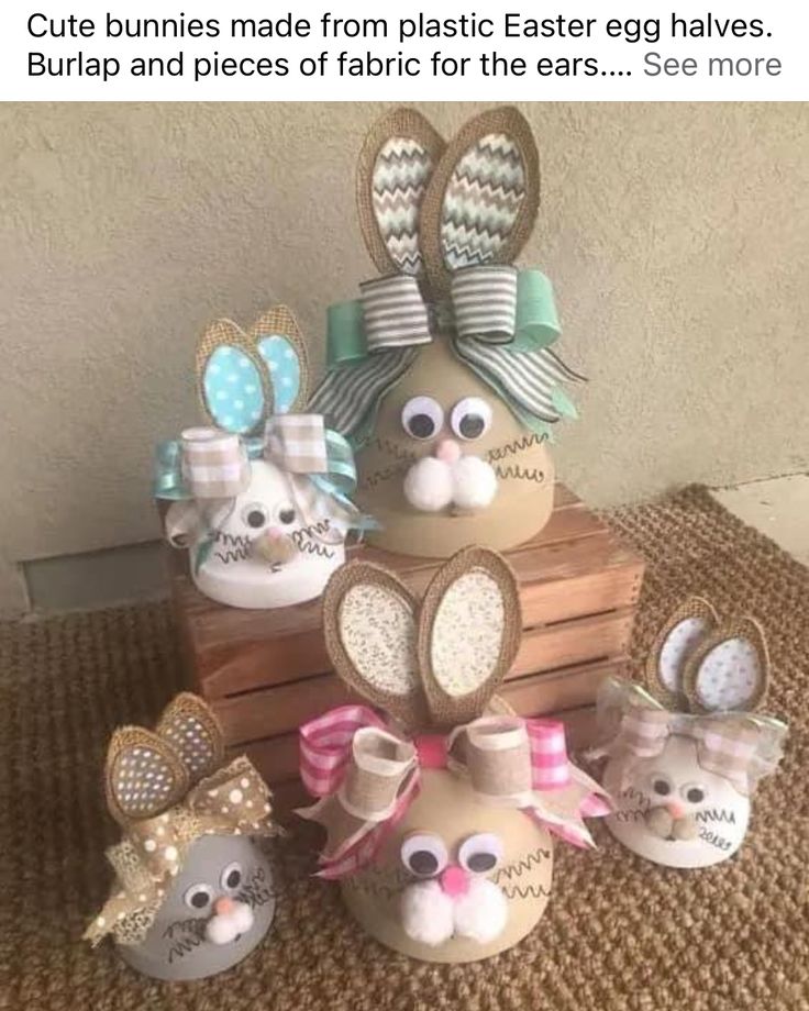 some bunny decorations are sitting on top of a wooden crate with bows and ribbons around them