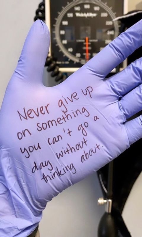 a glove with writing on it that says never give up on something you can't go through without thinking about