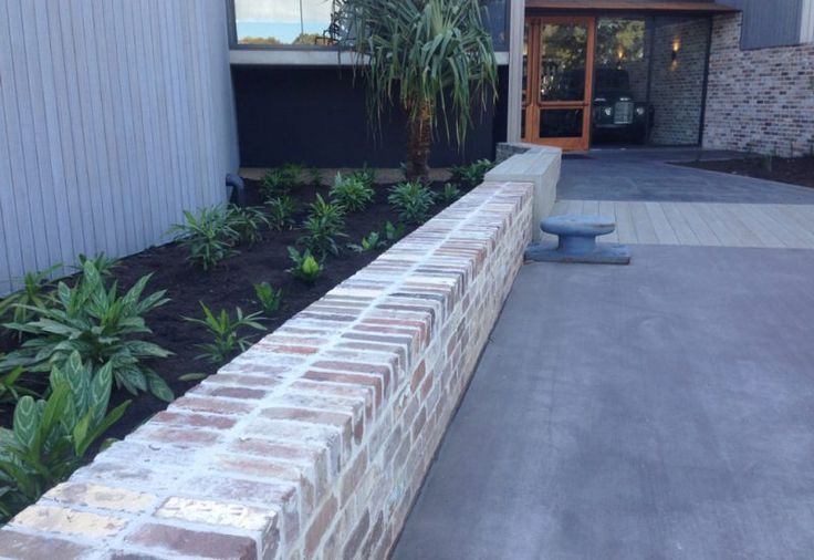 a brick planter in front of a building