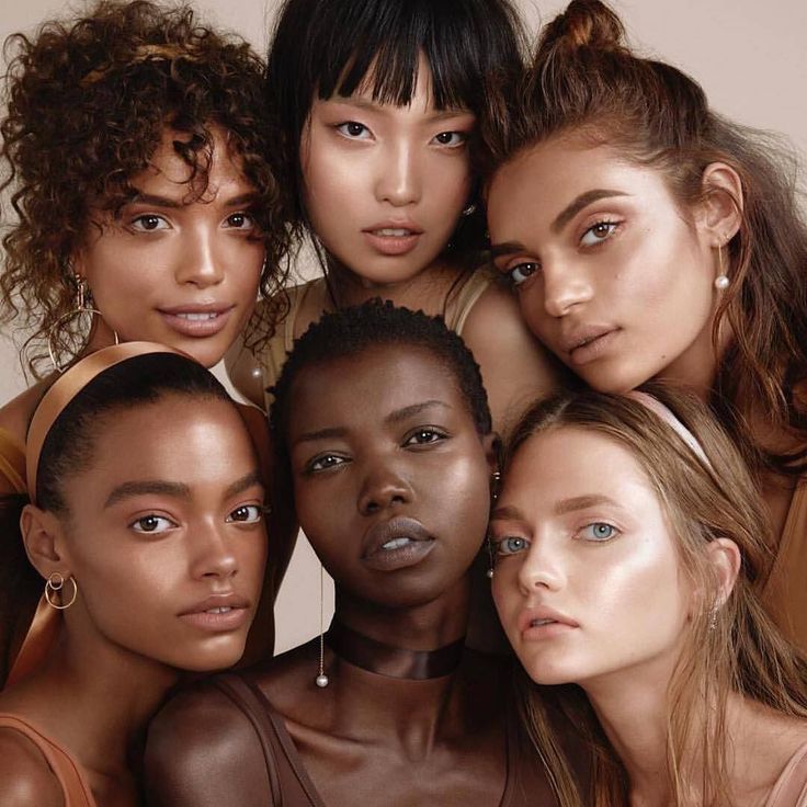 five models pose together in front of a white background