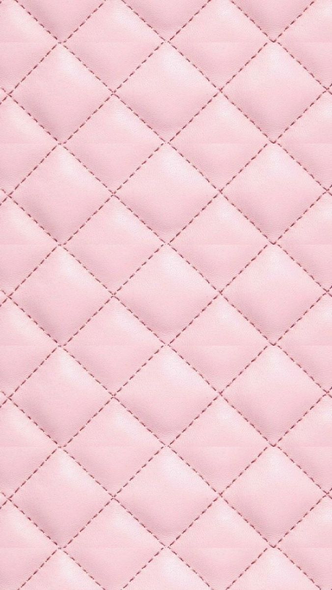 a pink quilted material with white stitching