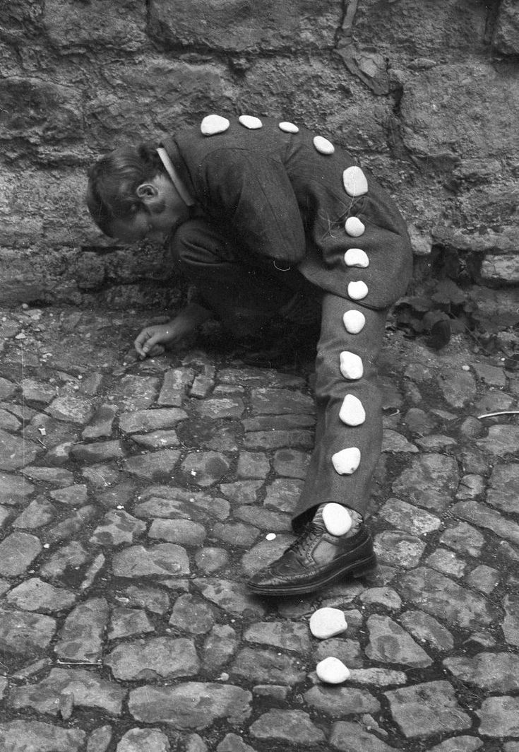 a man is sitting on the ground with his head down