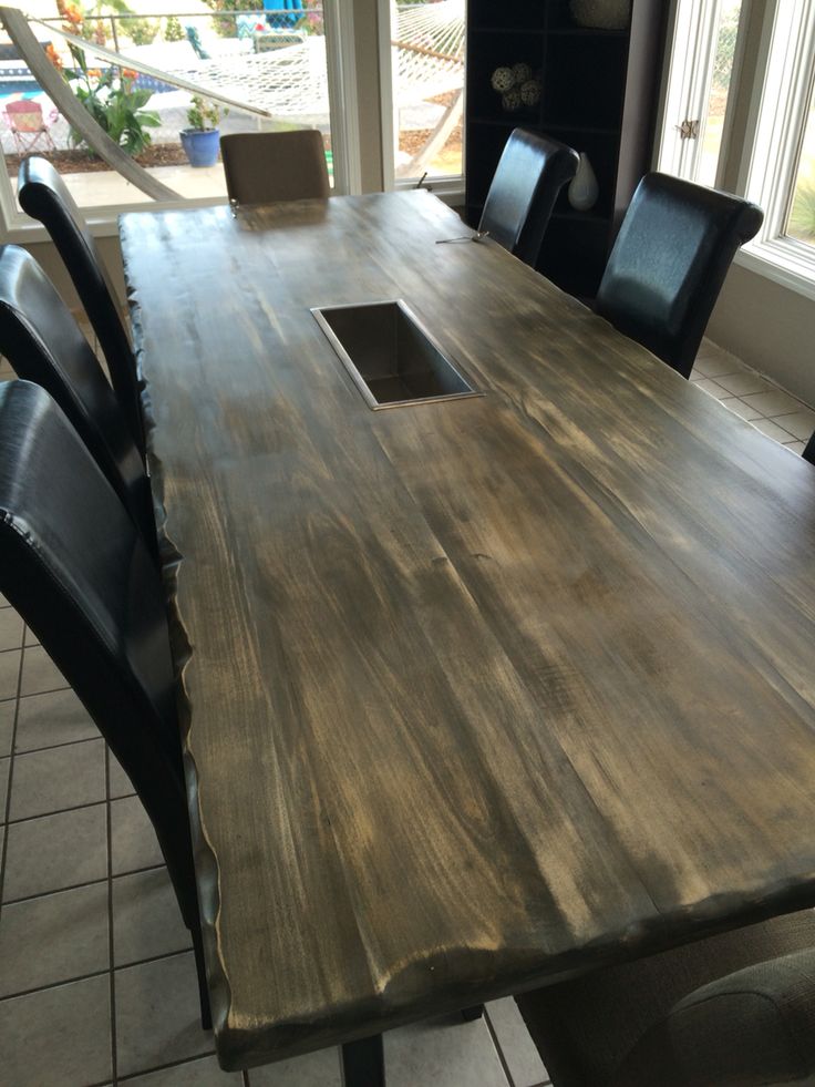 a large wooden table with black chairs around it