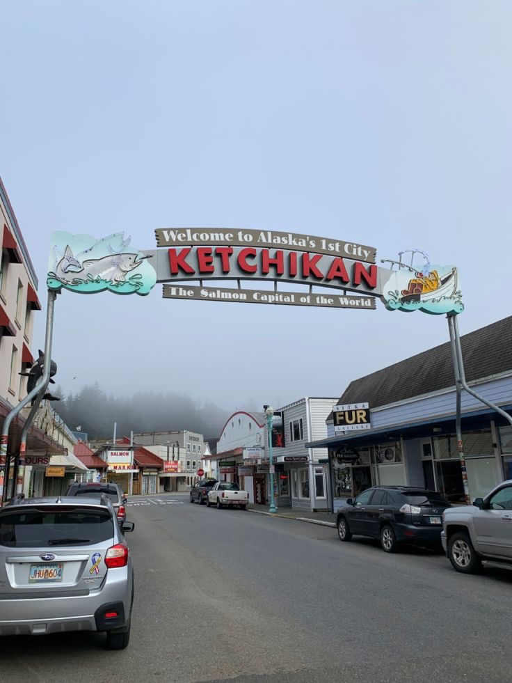 cars are parked on the street in front of shops and businesses with a sign that reads ketchikan