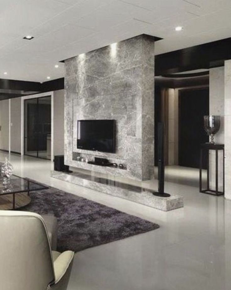 a modern living room with black and white walls, carpeted flooring and furniture