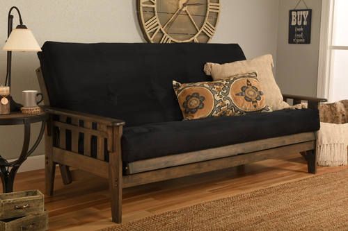 a living room with a futon and wooden flooring in front of a clock on the wall