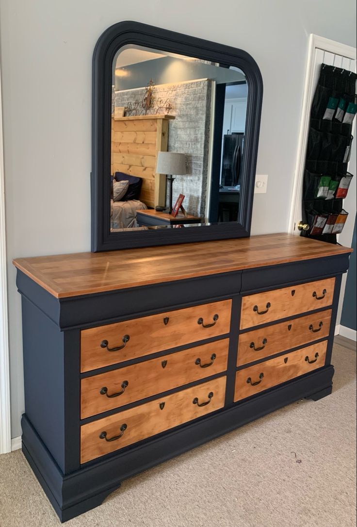 a dresser with a mirror on top of it