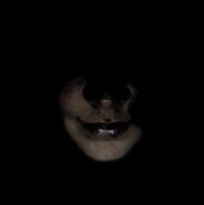 a creepy looking face in the dark