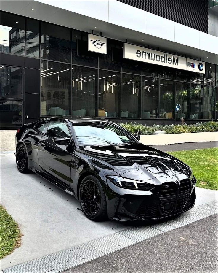 a black sports car parked in front of a building