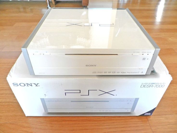 two new sony psx consolees sitting on top of each other in a room