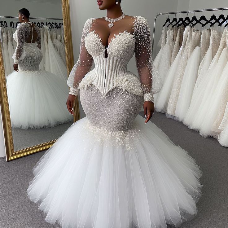 a woman standing in front of a mirror wearing a wedding dress