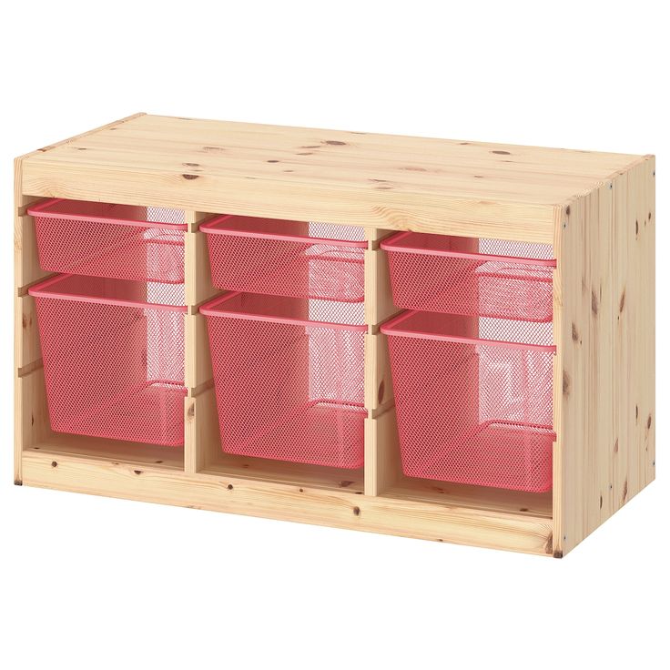 a wooden shelf with pink bins on it