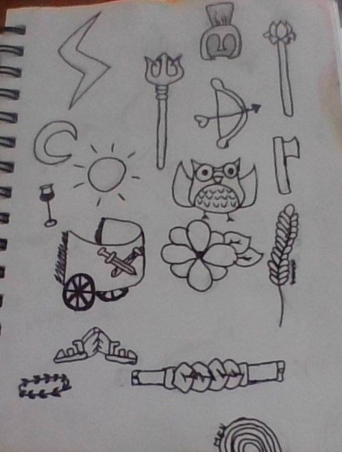 a notebook with some drawings on it and an owl sitting in the middle, surrounded by other items