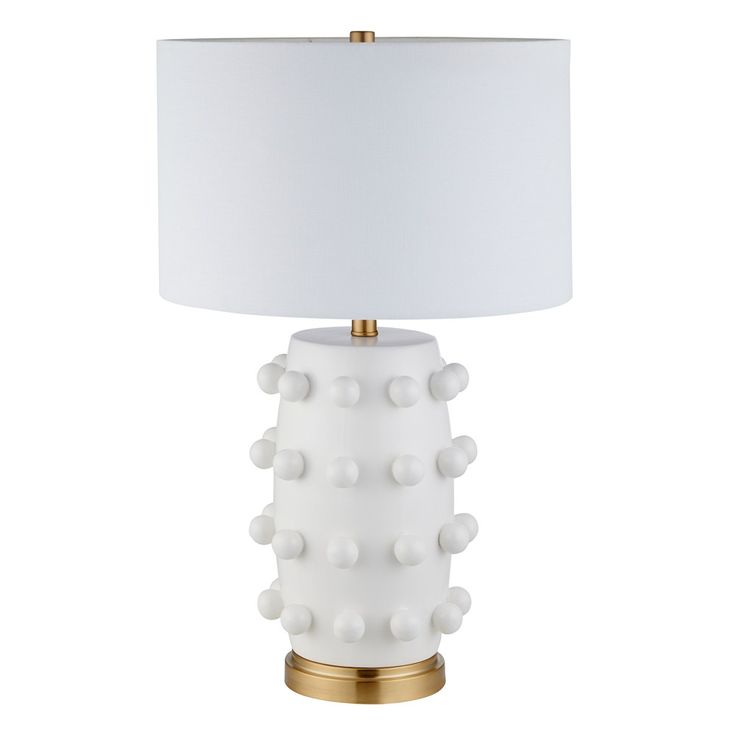 a white table lamp with a gold base