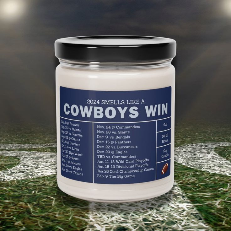 a jar of cowboy's win sits on the ground in front of a dark sky