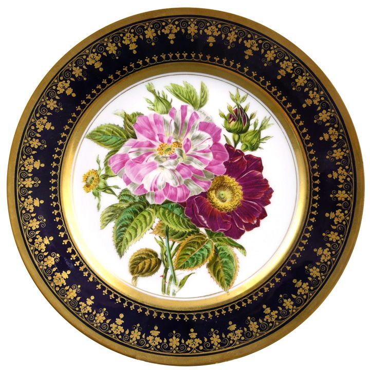 a plate with flowers painted on the side and gold trimmings around the edges