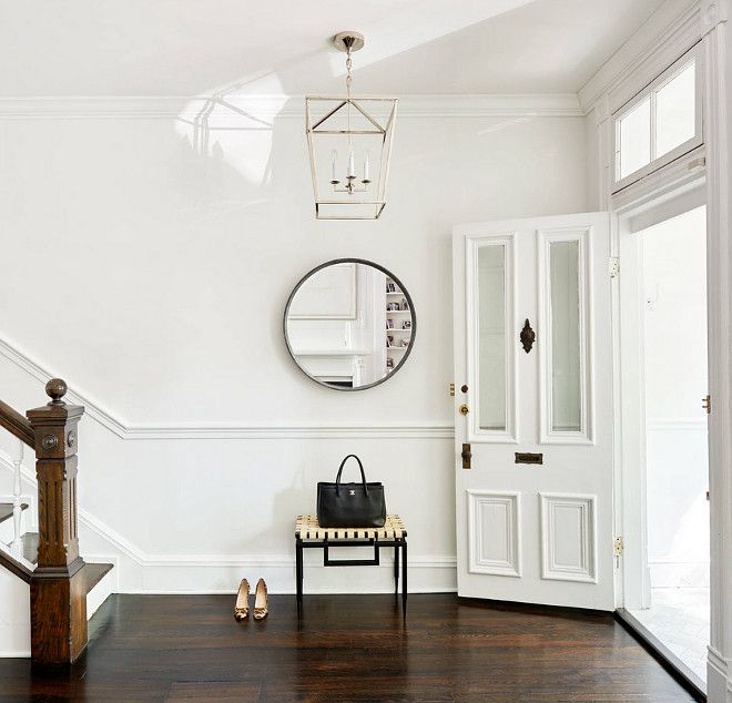 there is a purse and some shoes on the floor in this room with white walls