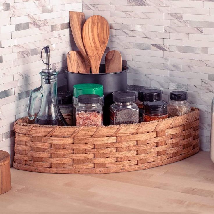 a kitchen counter with spices and utensils in a basket on the counter top