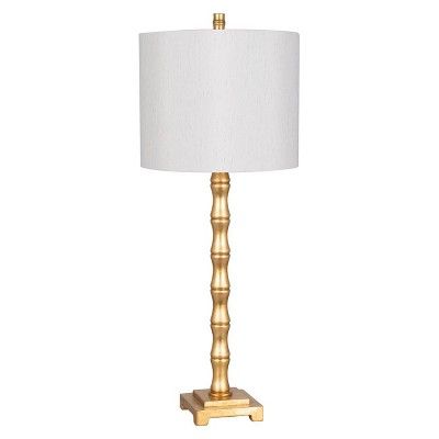 a gold table lamp with a white shade