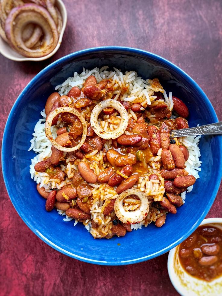 a blue bowl filled with rice and beans