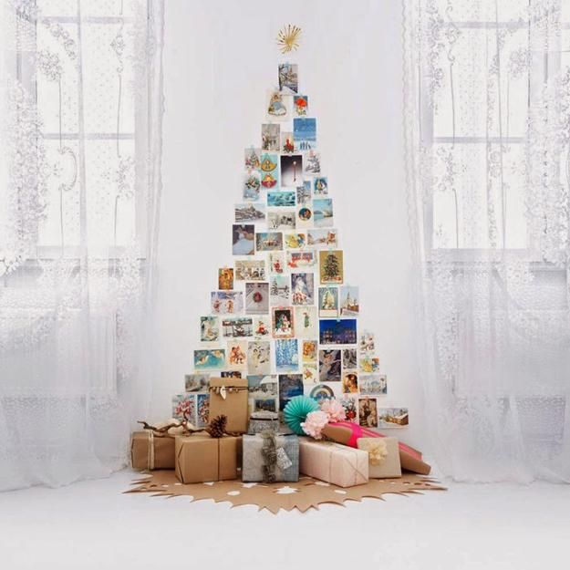 a christmas tree made out of photos with presents around it and wrapped in brown paper