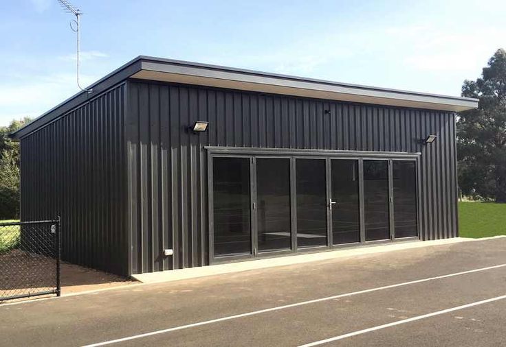 an empty parking lot next to a metal building