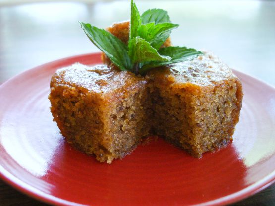 two pieces of cake sitting on top of a red plate with a green leaf sticking out of it