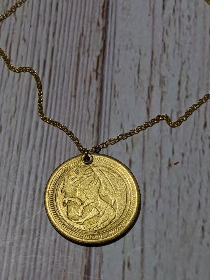 Beautiful gold dragon coin necklace!  Your chain can be made to any length, if you have a preference, send me a message! Thanks so much for looking! Gold-tone Pendant Medallion Necklace, Gold-tone Medallion Brass Chain Necklace, Dragon Medallion, Luxury Gold-tone Medallion Pendant Necklace, Yellow Gold Dragon Pendant Jewelry, Gold Medallion Necklace, Gold Dragon, Gold Coin Necklace, Gold Medallion