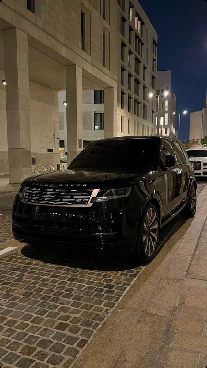 a black suv parked on the side of a street