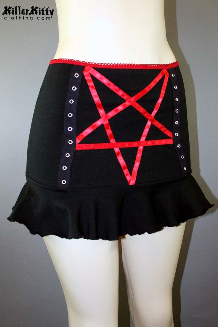 DETAILS Custom-made pentagram mini skirt created using red satin ribbon with black grommet tape on the front and a red elastic waist band. LENGTH: 13" (fits at hip) MODEL: Mannequin has 37" hip VIEW SIZE GUIDE CARE: Hand wash cold, hang dry. SHIPPING: Made When Ordered Please allow 1-2 WEEKS to ship. Gothic Mini Skirt For Halloween Festival, Gothic Halloween Festival Mini Skirt, Stretch Halloween Mini Skirt, Emo Fitted Mini Skirt For Cosplay, Emo Mini Skirt For Halloween Cosplay, Gothic Stretch Mini Bottoms, Emo Fitted Mini Skirt, Alternative Fitted Mini Skirt For Halloween, Halloween Stretch Mini Skirt