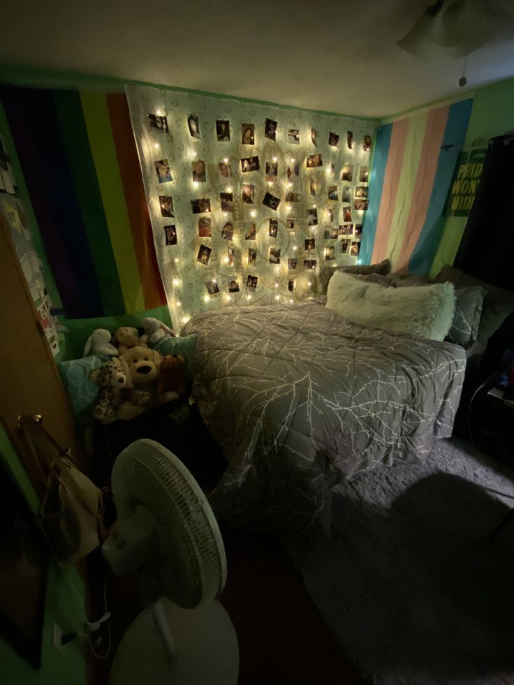 a bed room with a neatly made bed and lots of lights on the headboard