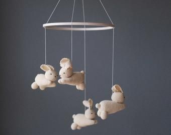 three stuffed animals are hanging from a mobile